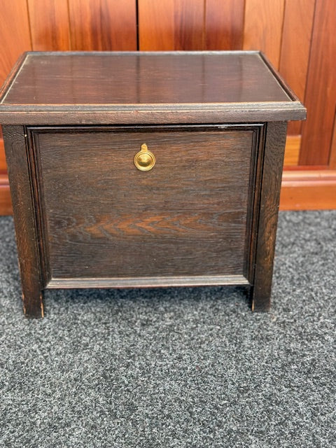 Small Dark stained wooden chest with a hinged lid and a small brass-toned pull handle