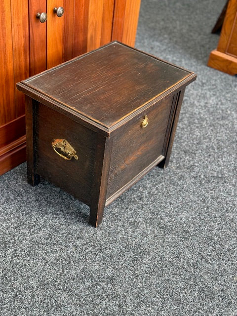 Small Dark stained wooden chest with a hinged lid and a small brass-toned pull handle