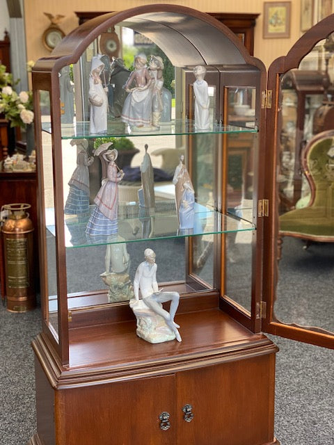 A tall vintage Mahogany arched Mirror-back display cabinet