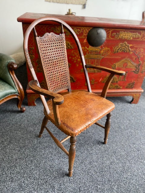 A Stunning antique leather and cane rattan chair