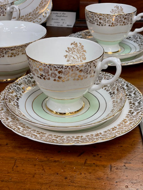 A Tuscan porcelain tea cup and saucer set with matching plates, bowls, and a creamer.