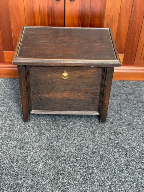 Small Dark stained wooden chest with a hinged lid and a small brass-toned pull handle