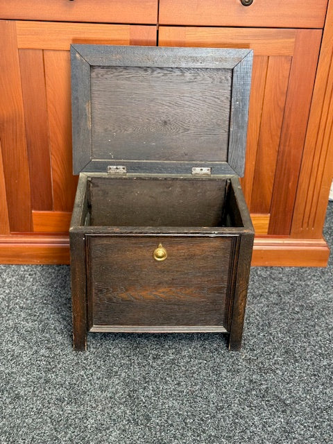 Small Dark stained wooden chest with a hinged lid and a small brass-toned pull handle