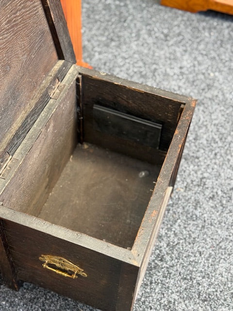 Small Dark stained wooden chest with a hinged lid and a small brass-toned pull handle